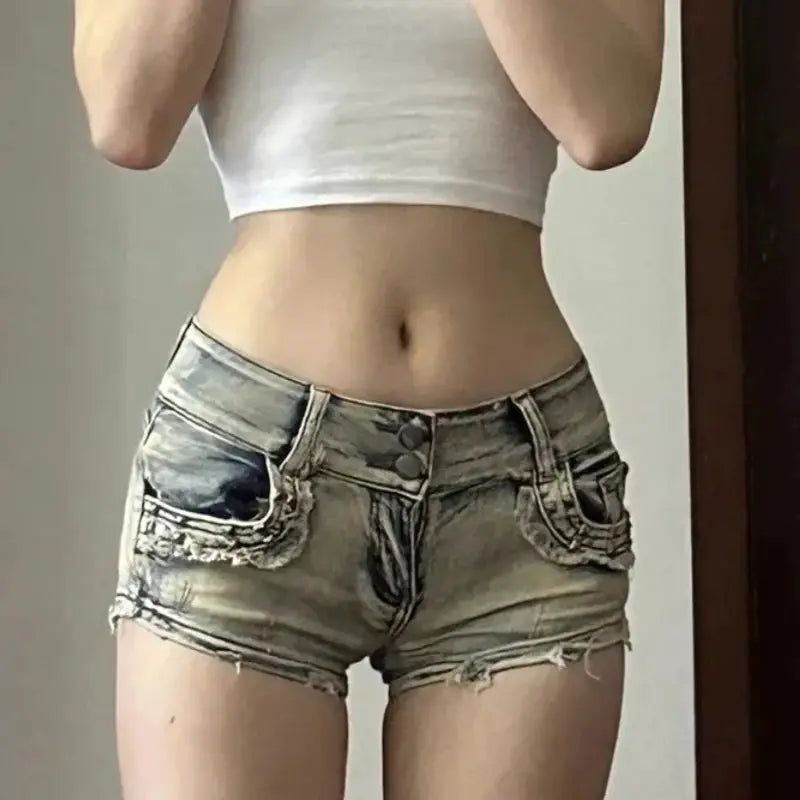 Skinny denim shorts, light-wash with distressed patch pockets and frayed hems, low-rise