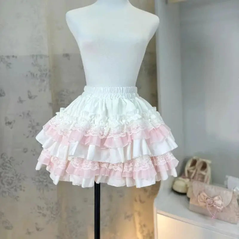 Lolita style princess cake skirt by Simples Market, white with pink lace-trimmed ruffles, mini length.
