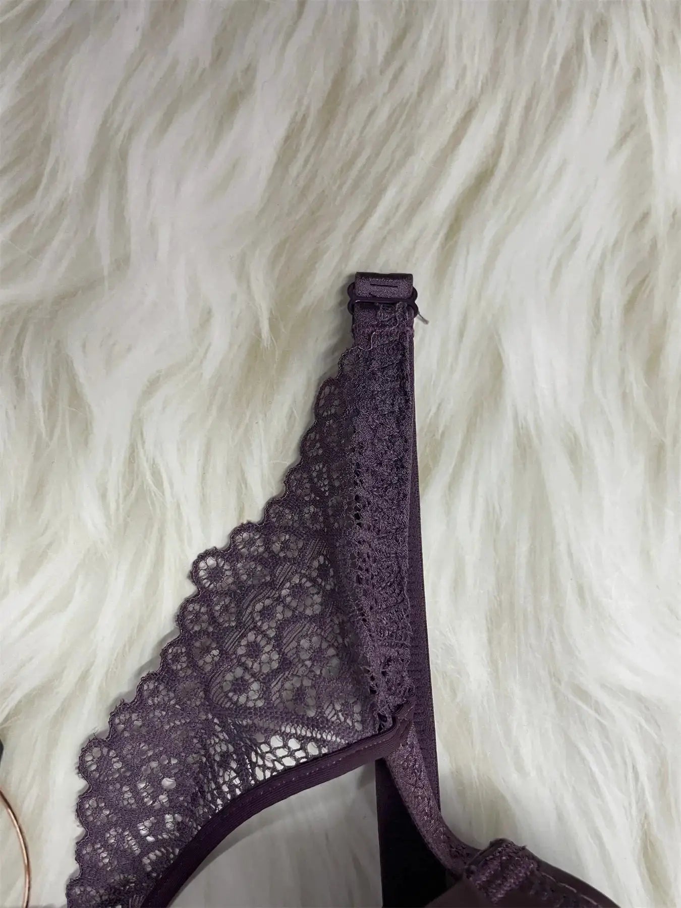 Purple lace underwire bra with scalloped edges and thin straps; elegant floral lattice pattern on deep purple fabric