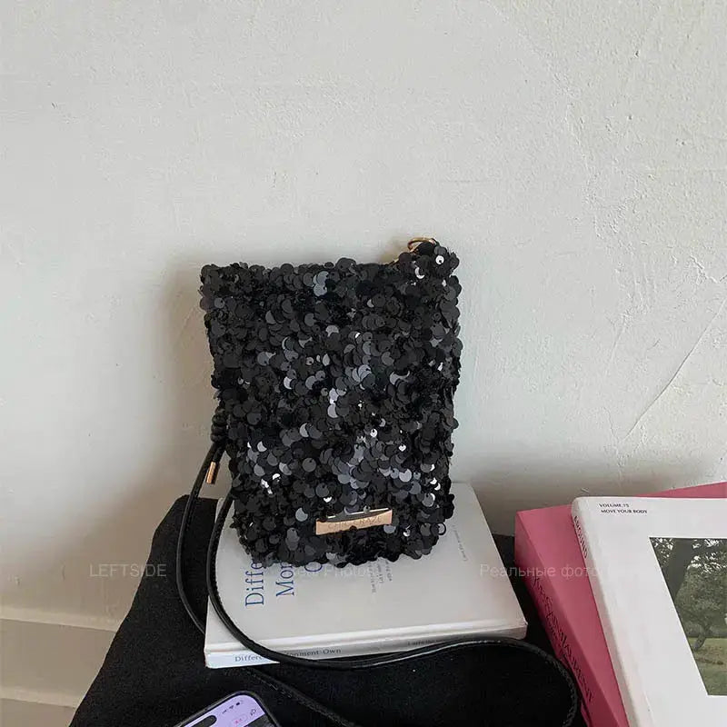 LEFTSIDE mini sequins shoulder bag, black crossbody with gold bar accent.