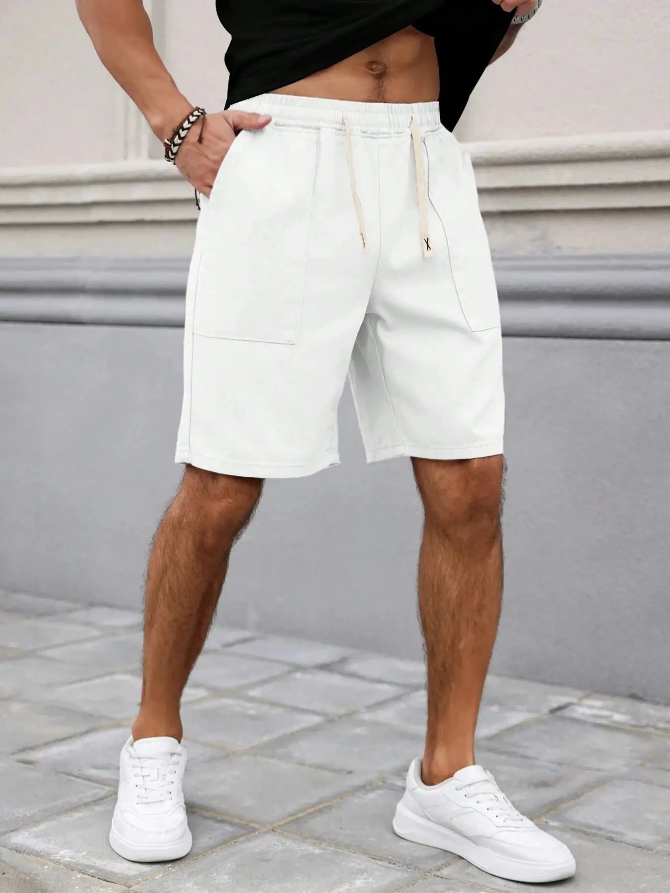 Men's light gray mid-length shorts with drawstring waist and front patch pockets