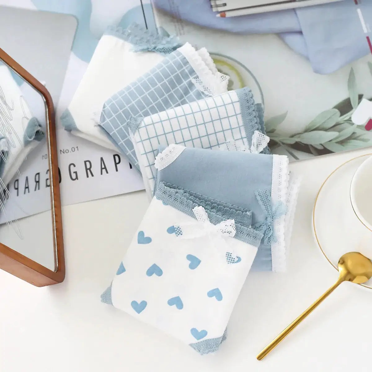 5-pack cotton panties set; Simples Market mid-rise briefs in white and light blue with lace trim, heart and grid prints.