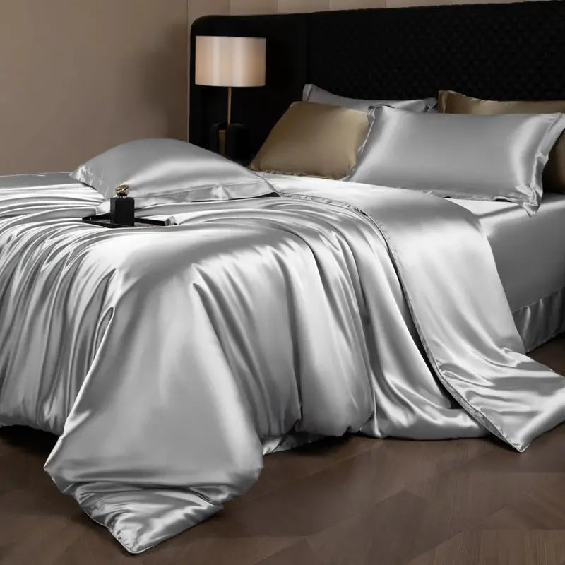 Silk satin bedding set with duvet cover, fitted and flat sheets, and pillowcases in silver