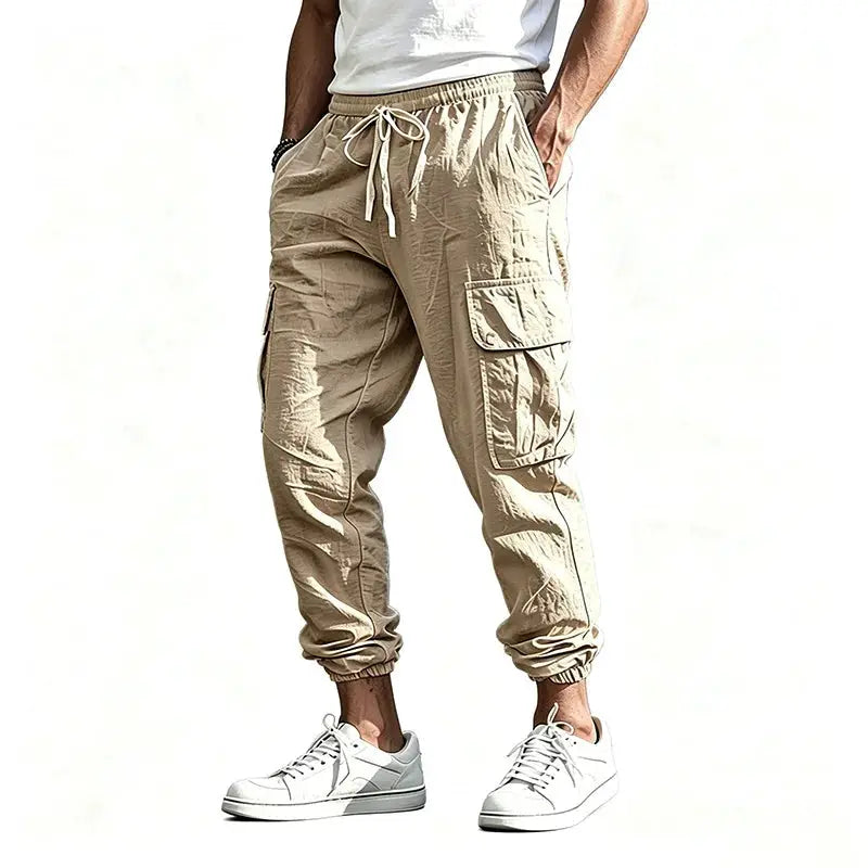 Men's cargo jogger pants in tan cotton-linen blend with drawstring waist, elastic cuffs, and multiple pockets