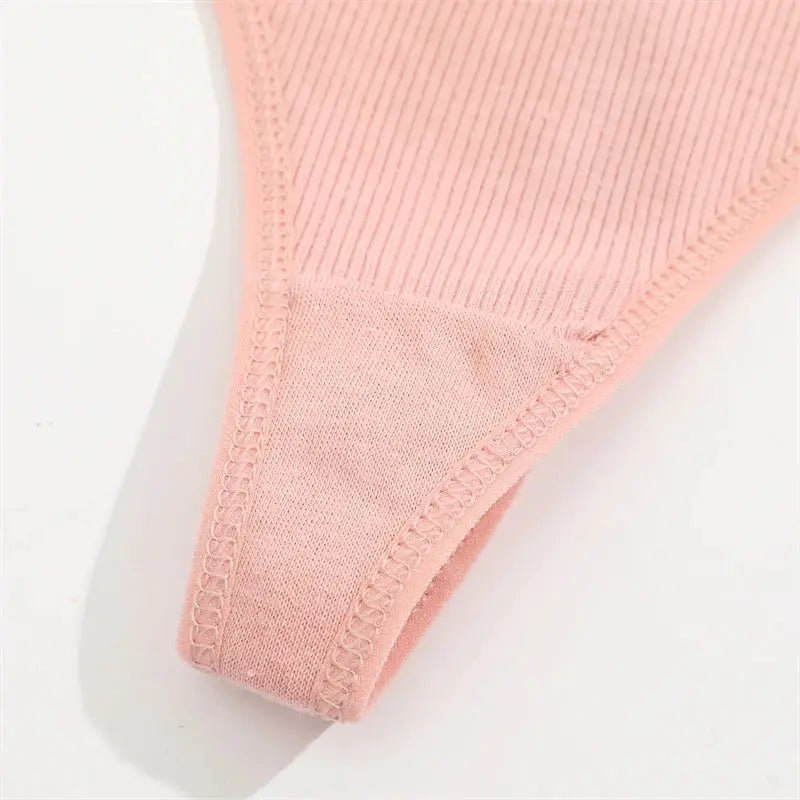 FINETOO pink thong underwear close-up, low-rise with stitched edges.