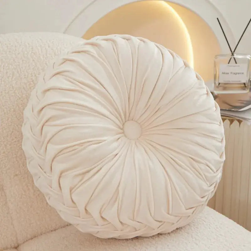 Simples Market round lumbar cushion, cream Dutch velvet with hand-sewn radial pleats.