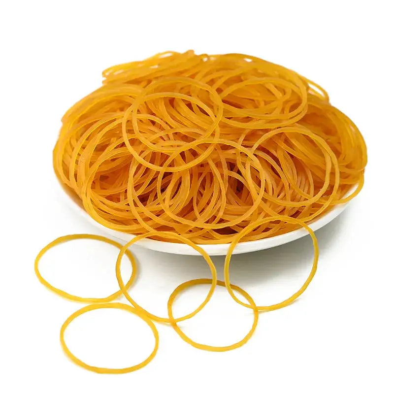 Yellow rubber bands by Simples Market in a white bowl; high-elasticity, high-temperature resistant set.