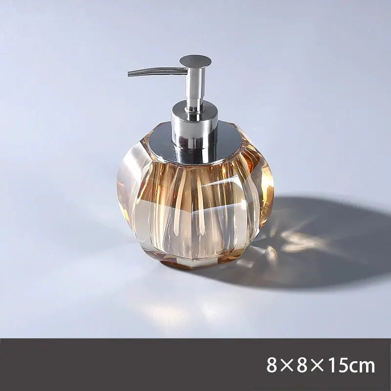 Glass lotion dispenser by Simples Market; faceted clear bottle with metal pump, bathroom set