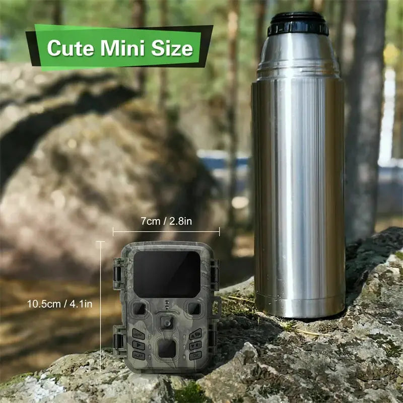 Suntekcam mini camo trail camera beside a stainless steel thermos outdoors; 2 items shown.