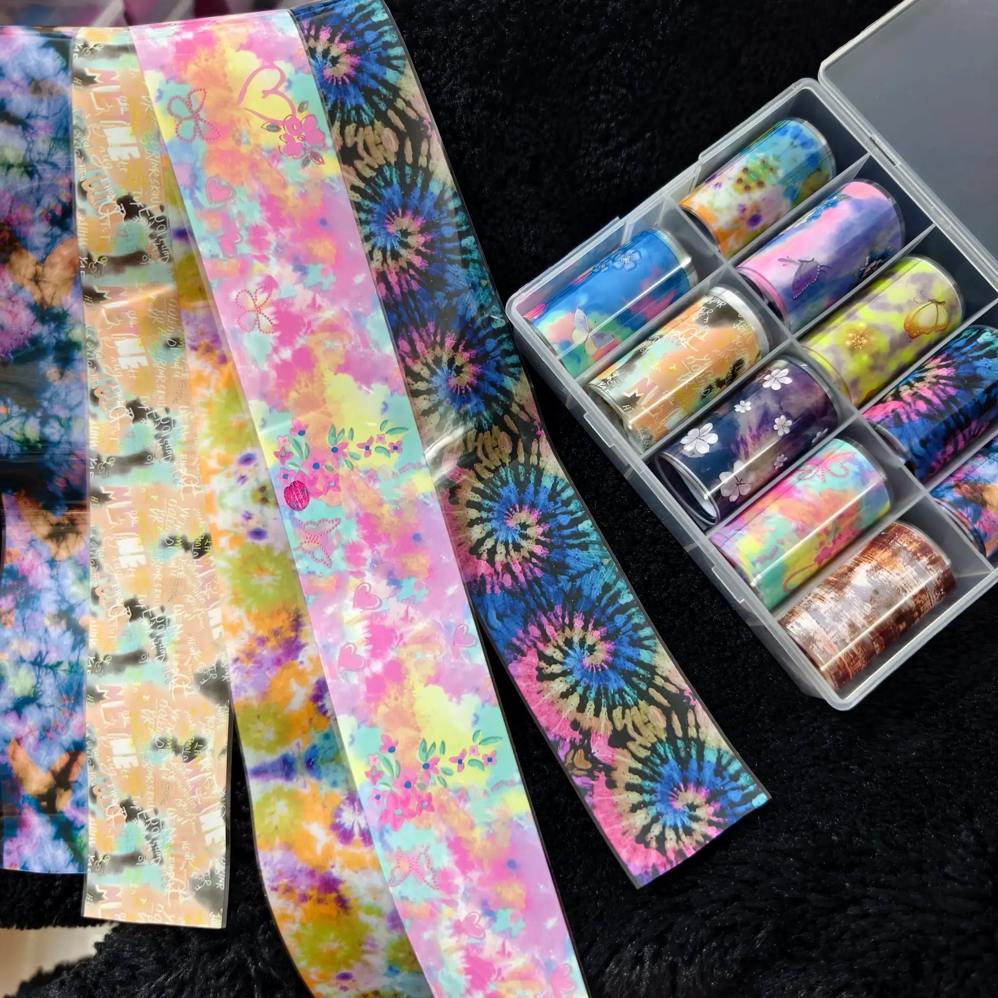 Simples Market 10-roll nail foil set with colorful tie-dye, floral and bow designs in clear organizer