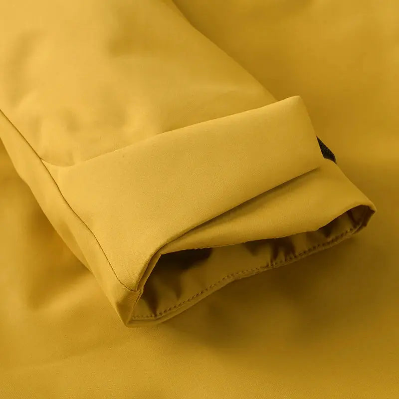JNLN Unisex Waterproof Fleece Jacket cuff in mustard yellow fabric