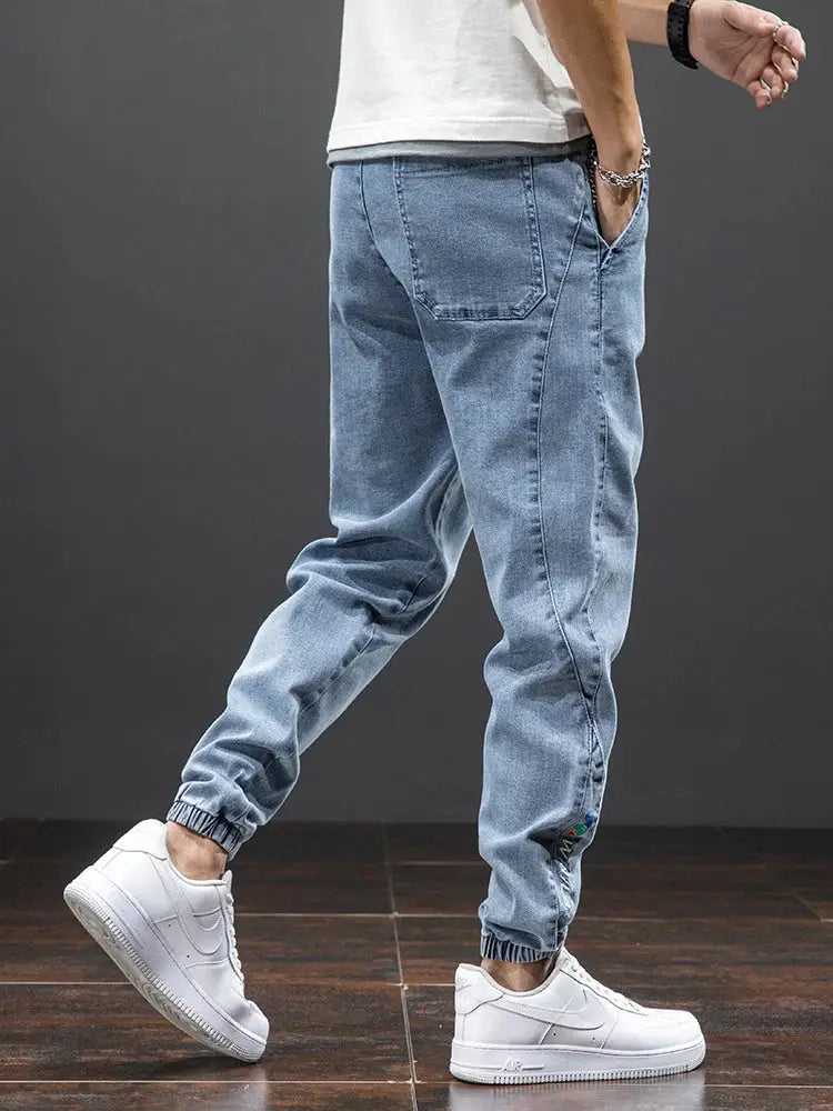 Men's light blue denim cargo jogger pants with elastic cuffs and back pocket by Simples Market, streetwear