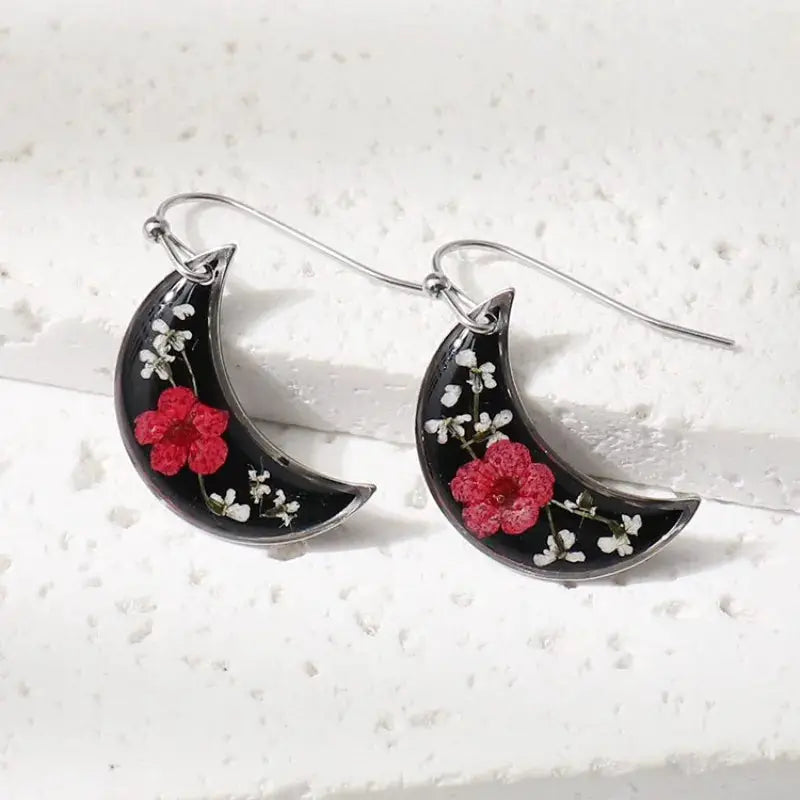 Simples Market crescent moon epoxy resin earrings, a pair with red flowers and white blossoms on black background