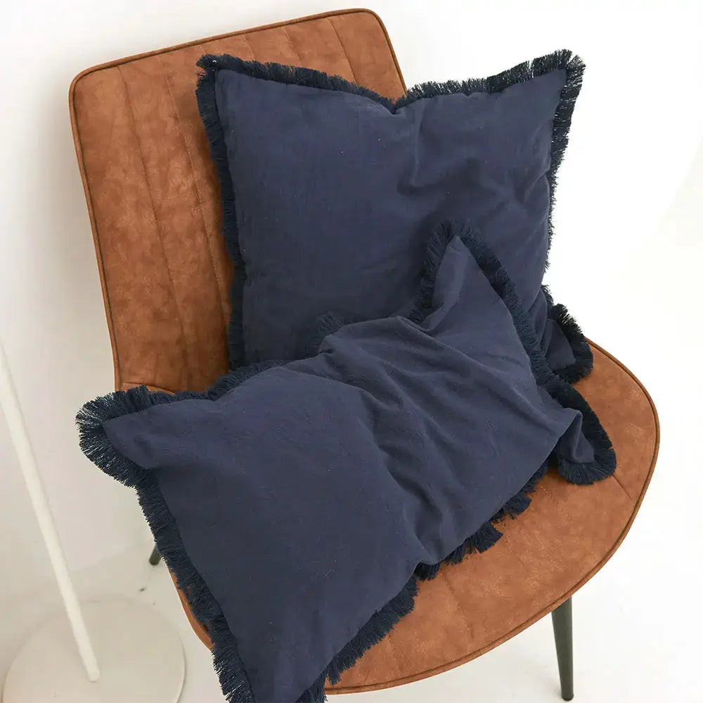 Cushion cover with navy tassel fringe for a square Nordic-style throw pillow