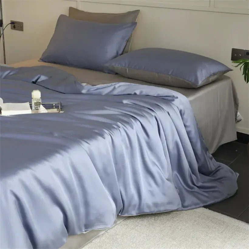 Mulberry Silk Bedding Set by Simples Market in blue satin; includes duvet cover, sheets and pillowcases.