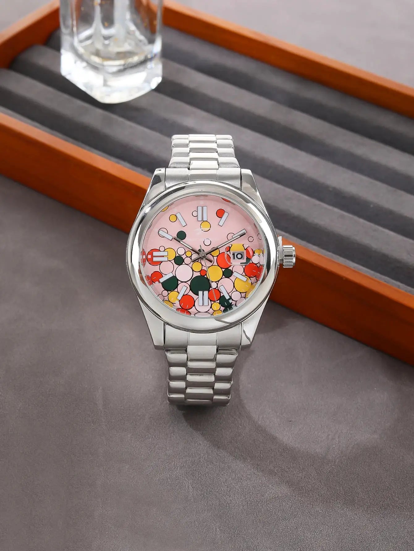 Men's stainless steel quartz watch with pink dial featuring a colorful circle pattern