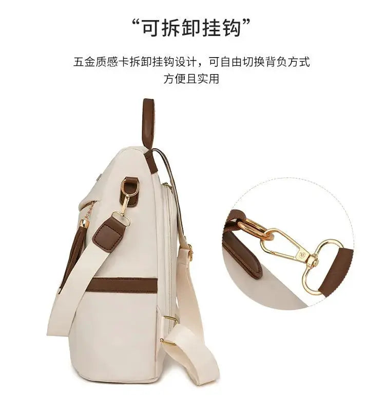Nylon anti-theft backpack in beige with brown leather trim, tassel detail and gold-tone hardware, adjustable shoulder strap