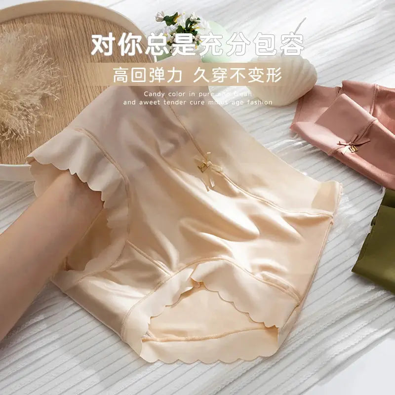 Silk panties set of four mid-rise briefs in peach, pink, and olive tones with scalloped hems and bow accents.