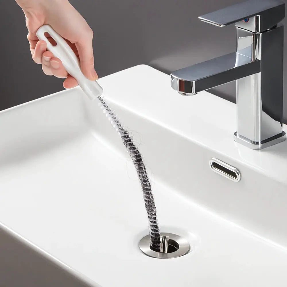 Drain cleaning brush with white handle and flexible metal coil for sink drains by Simples Market
