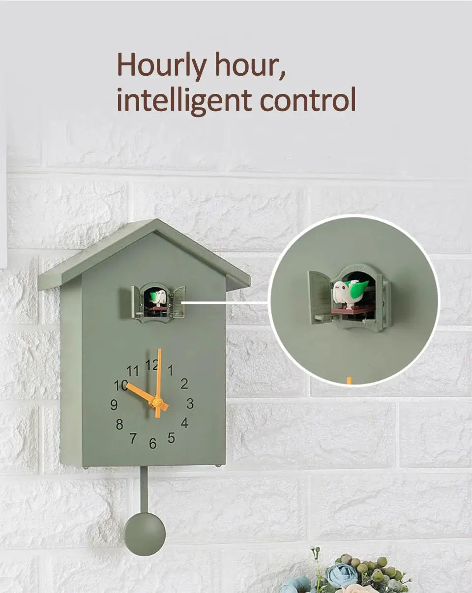 Wall cuckoo clock with quartz movement in sage green, orange hands, small bird door and pendulum