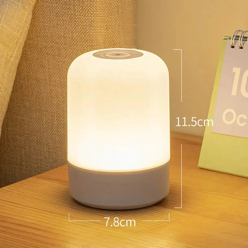 LED bedside lamp with touch dimmable light, frosted white shade and white base, 11.5 cm tall and 7.8 cm wide