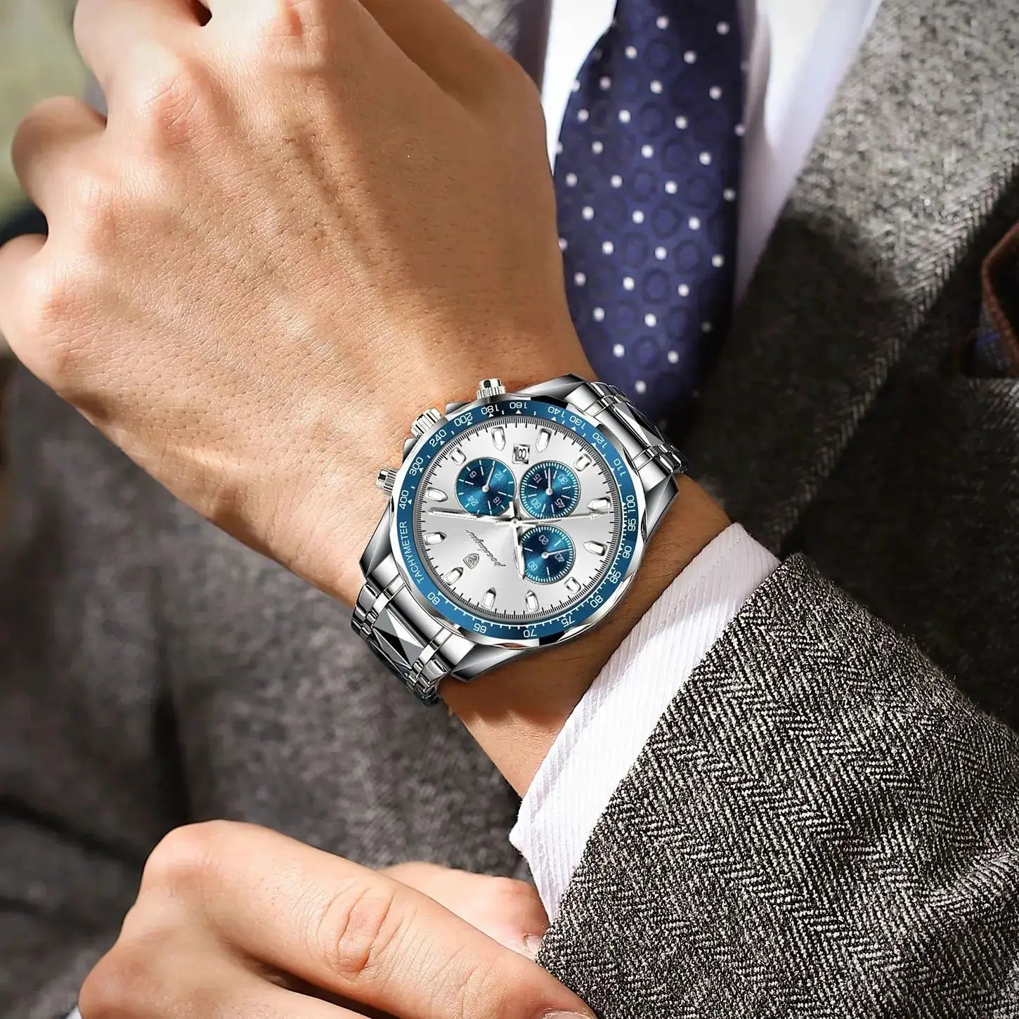 POEDAGAR luxury men's chronograph watch with stainless steel bracelet, blue bezel and white dial.