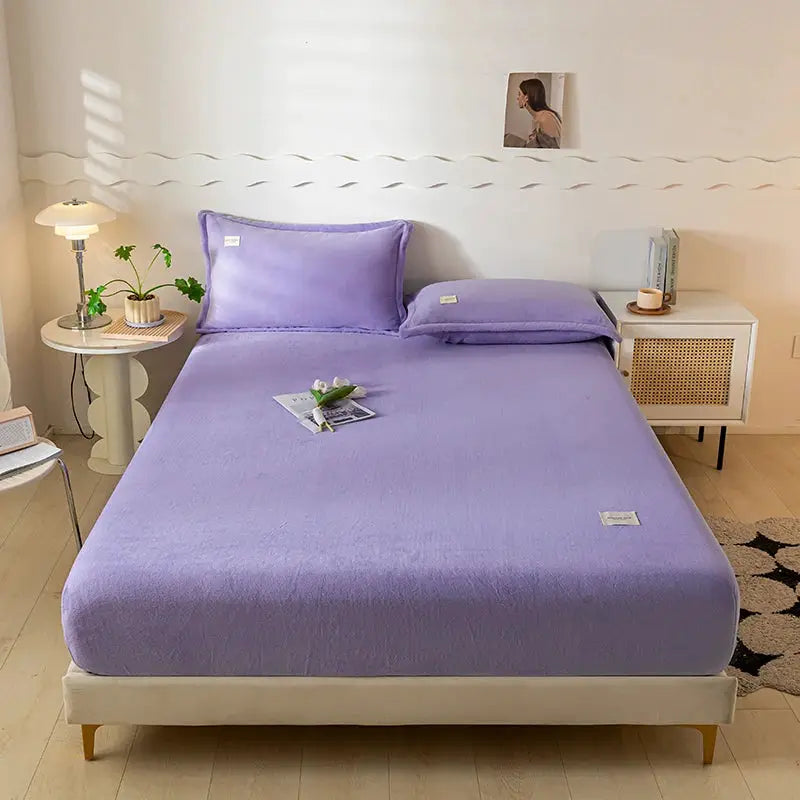 Velvet Thermal Mattress Cover by Simples Market in lavender on a bed with plush sheets