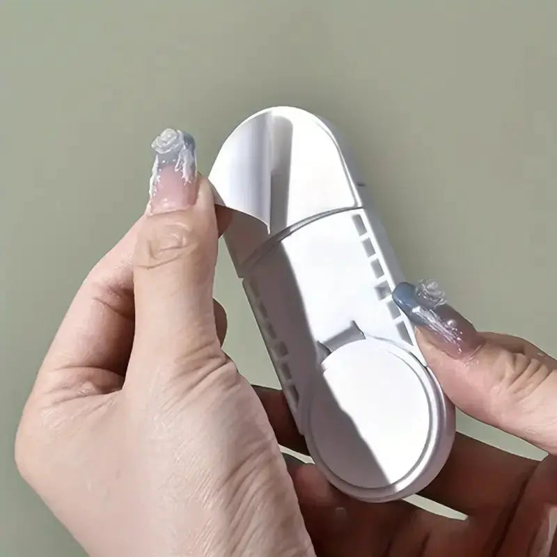 3-piece invisible magnetic cabinet lock for child safety; white plastic device held in hands
