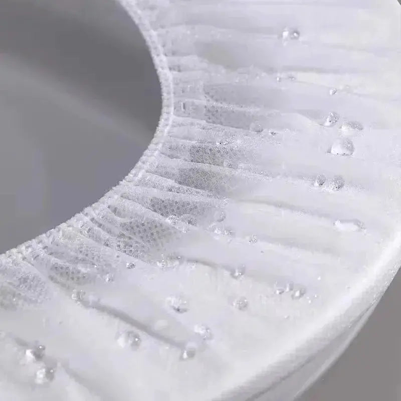 Roll of white disposable toilet seat covers, waterproof non-woven material for travel and hotel bathrooms