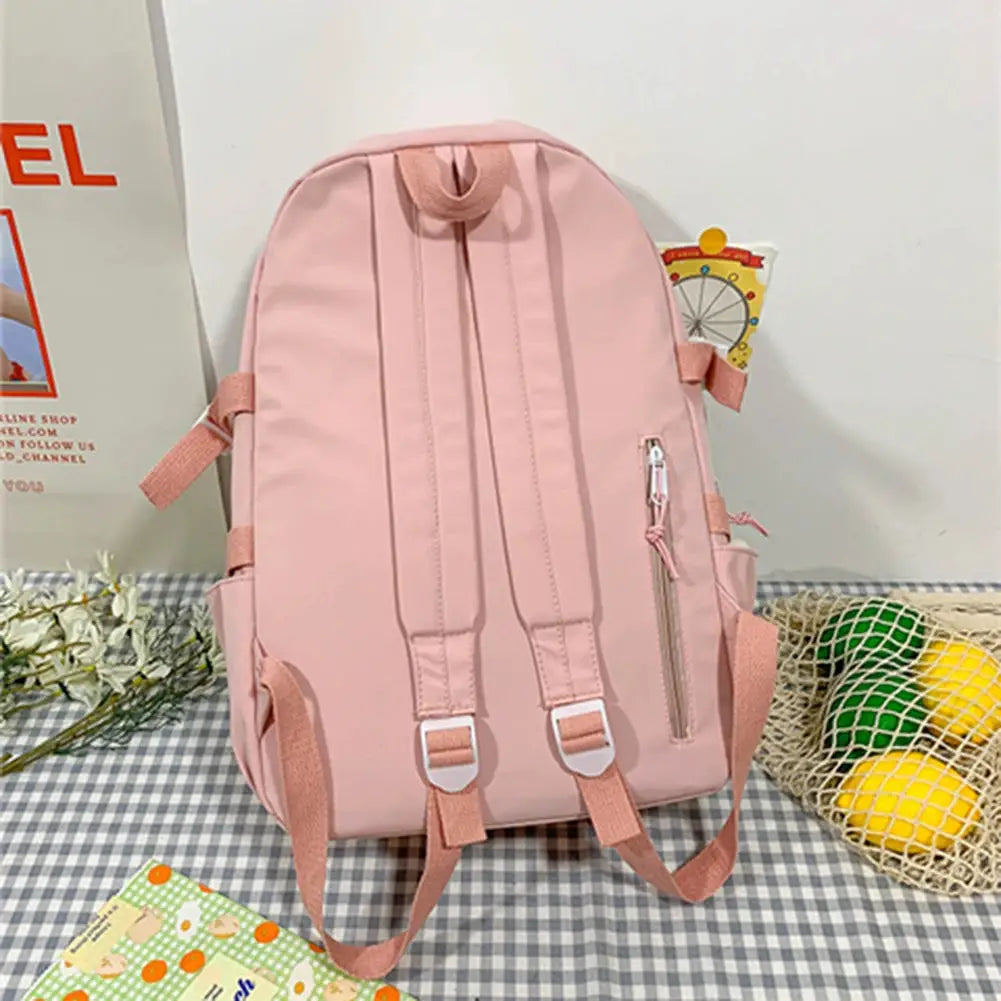 Pink lightweight school backpack with multiple pockets, padded straps, and side zip pocket