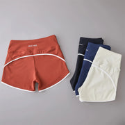 Peach high-waist sport shorts with white piping and elastic trim; Crazy Seed branding visible.