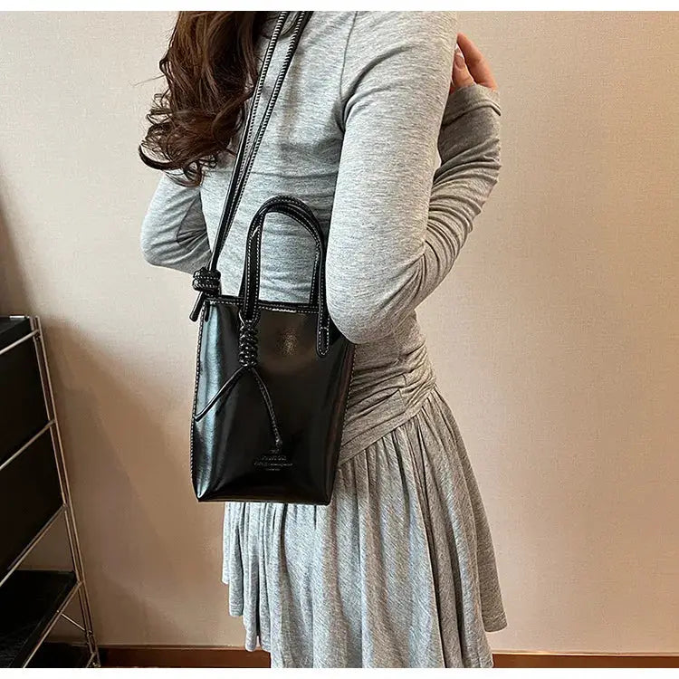 Black PU leather mini crossbody bag with top handles and long shoulder strap