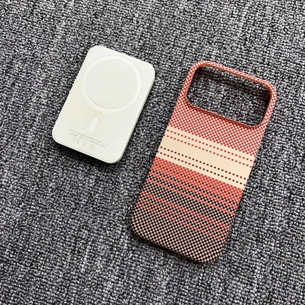 Phone case and MagSafe wireless charger; frameless carbon fiber Kevlar texture with red-beige checkered pattern.