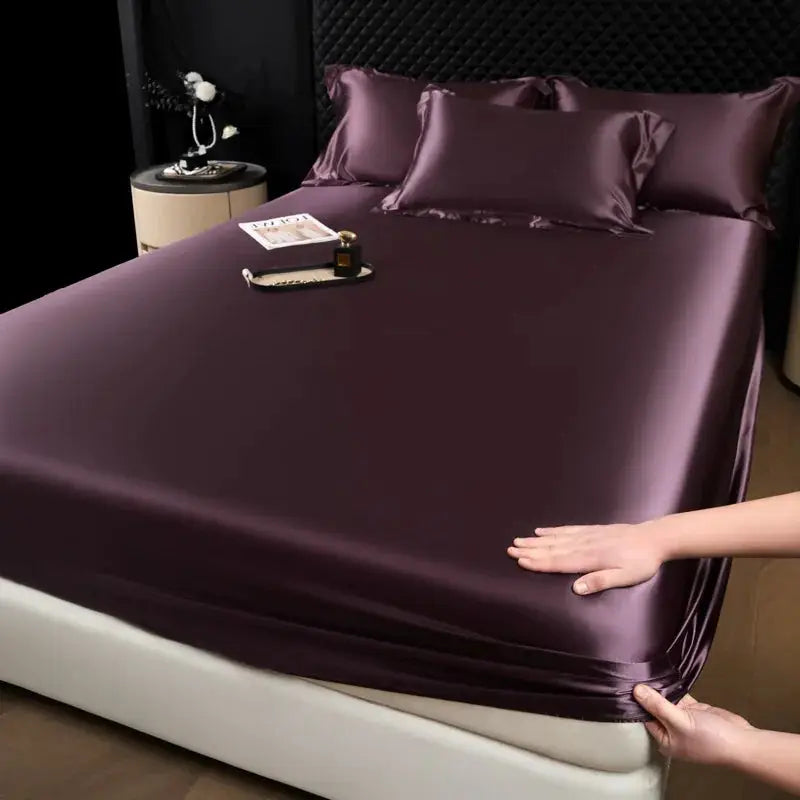 3-piece mulberry silk fitted sheet set with 2 pillowcases in burgundy satin on bed