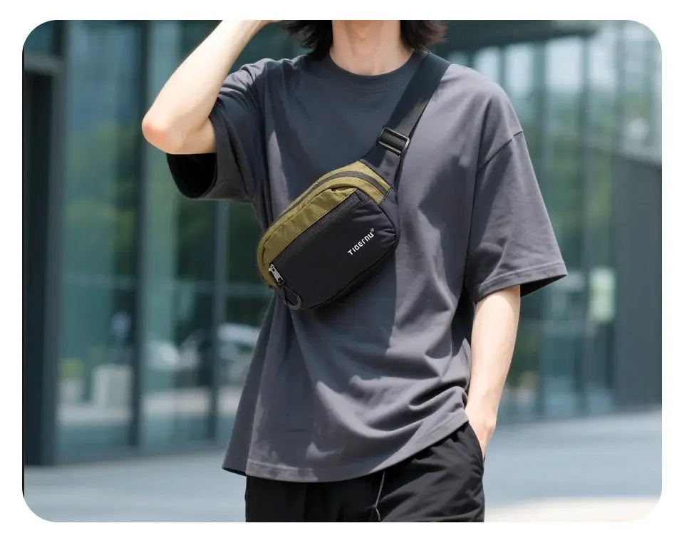 Tigernu crossbody sling bag in black with olive panel, worn across the chest