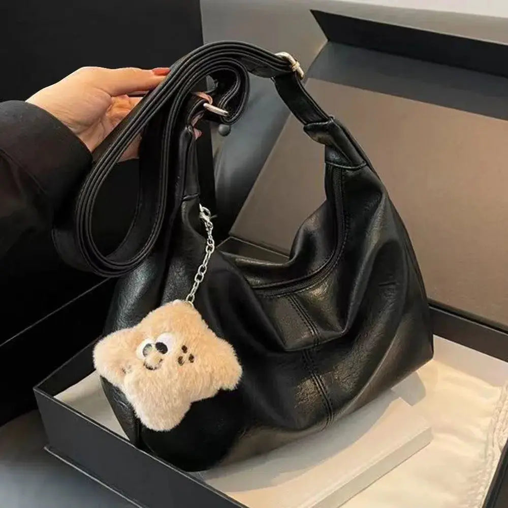 Black PU leather slouchy shoulder bag with teddy bear keychain; large-capacity retro hobo tote