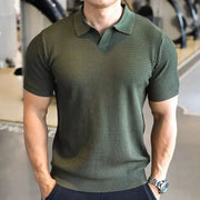 Men's olive-green knitted polo shirt with textured knit pattern, polo collar, and short sleeves.