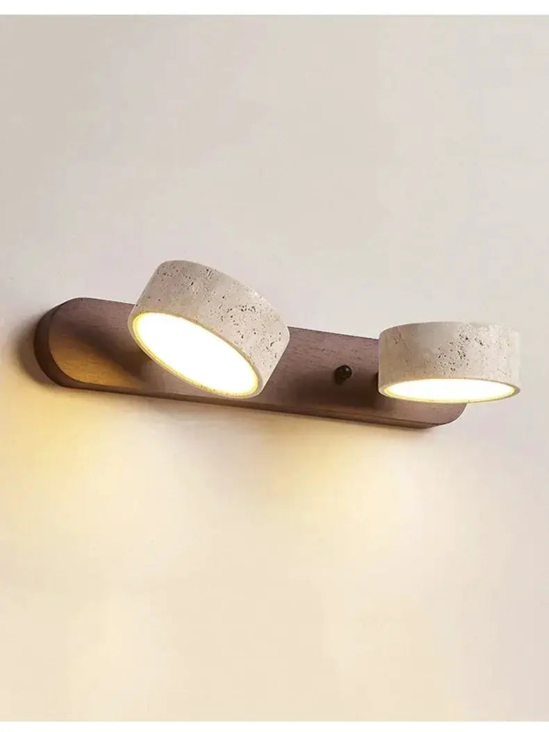 Round dual-LED wall light with concrete-style shades on a wooden backplate by Simples Market