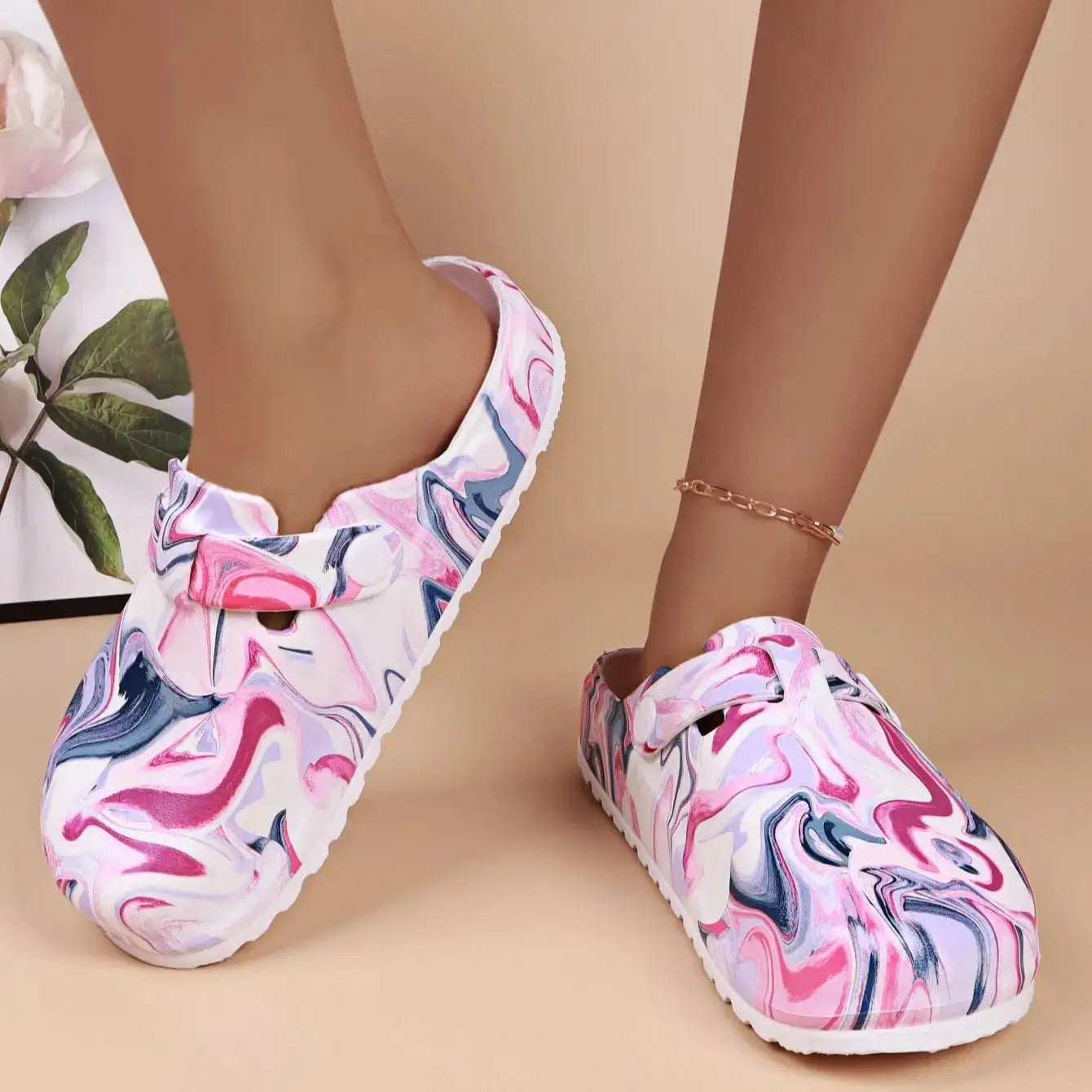 Women’s marbled pink EVA garden clogs; waterproof, lightweight slip-ons with white sole.