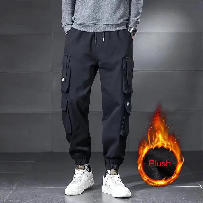 Men's black cargo pants with multiple pockets, drawstring waist, and elastic cuffs for outdoor wear.
