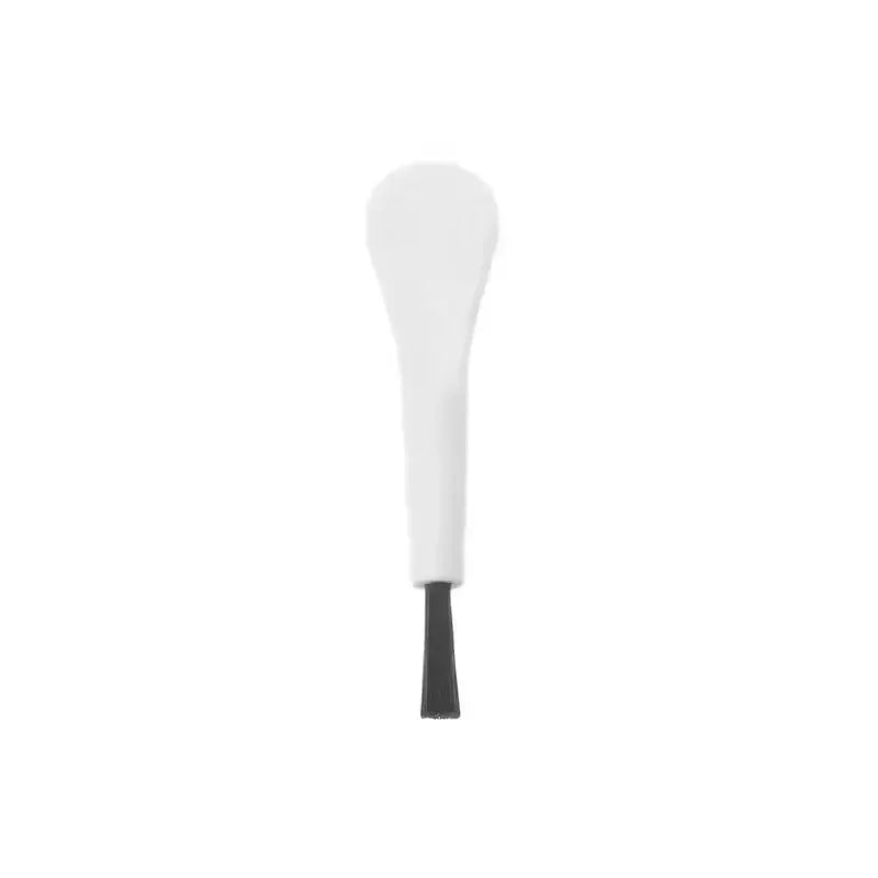 White handheld cleaning brush for mobile phone charging ports with black bristle tip