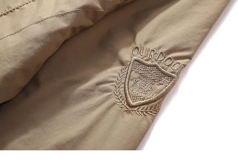 Simples Market outdoor waterproof jacket sleeve in tan with OURDOO shield logo patch and laurel embroidery