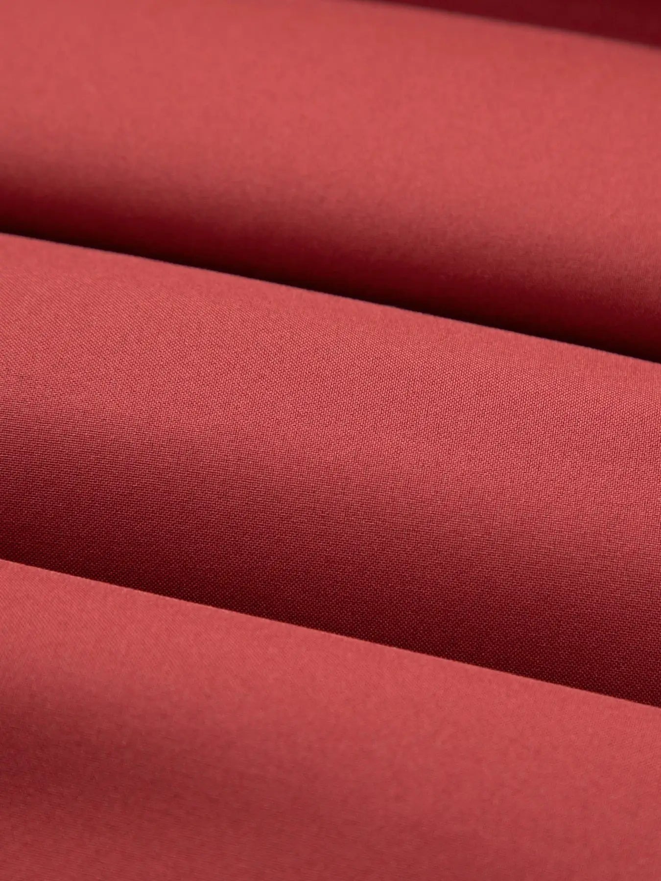 Men's cotton jacket fabric close-up in red, casual outerwear