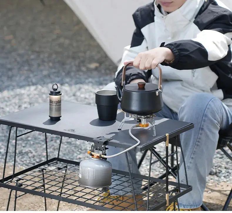 Hang Gas Canister Hook by Simples Market; black kettle on portable camping stove atop gray metal table outdoors