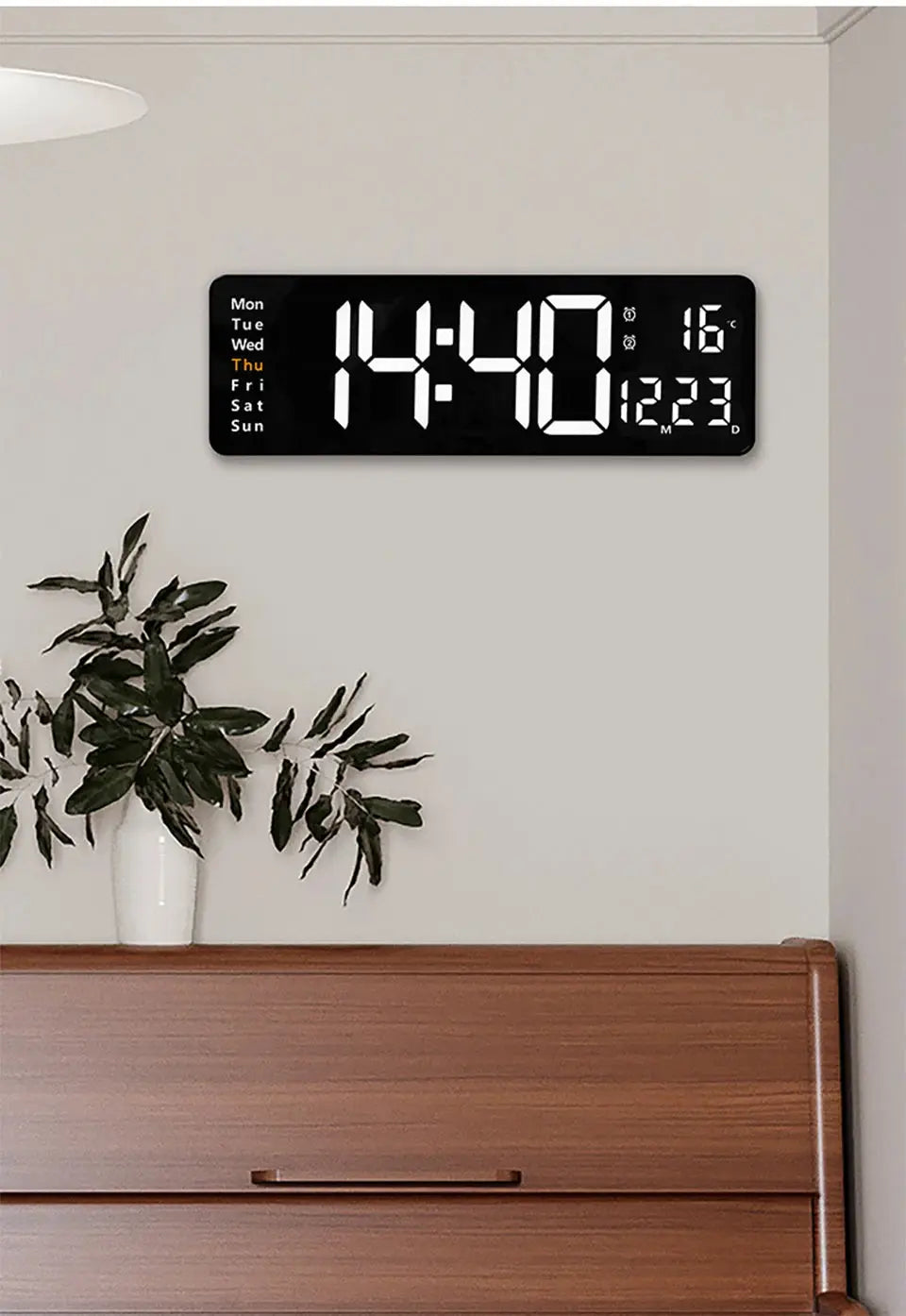 Large black digital wall clock by Simples Market with white LED digits displaying time, date, day, and temperature
