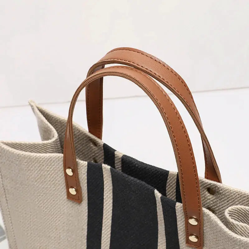 Bucket Handbag with beige canvas and black stripe pattern, brown leather top handles by Simples Market