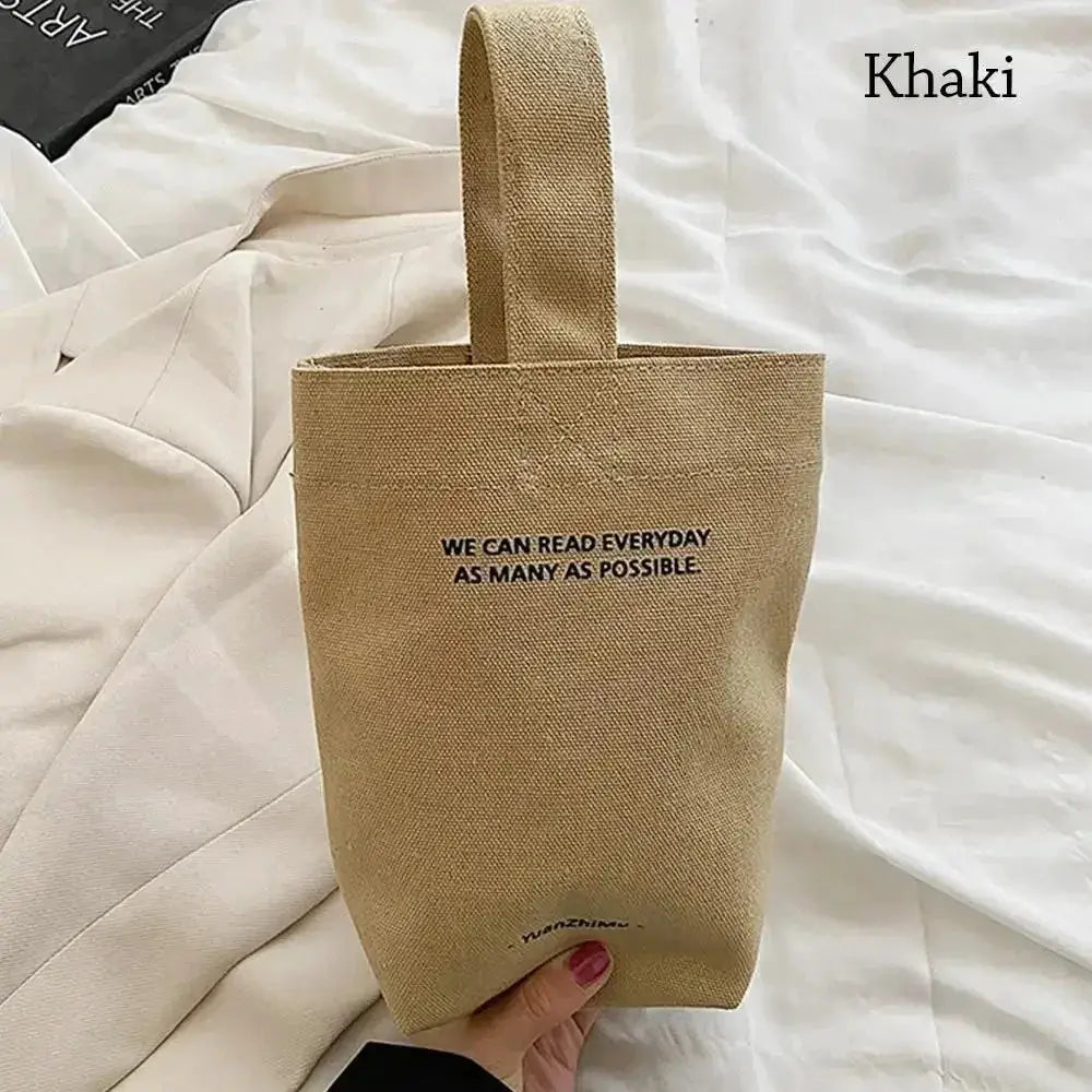 Khaki canvas tote bag with short strap, large-capacity shopper crossbody purse featuring printed slogan.