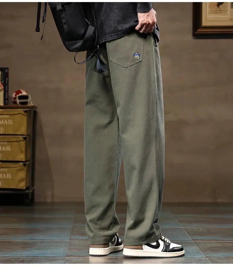 HIQOR men's cargo pants in olive cotton with a loose wide-leg fit and back pocket patch.