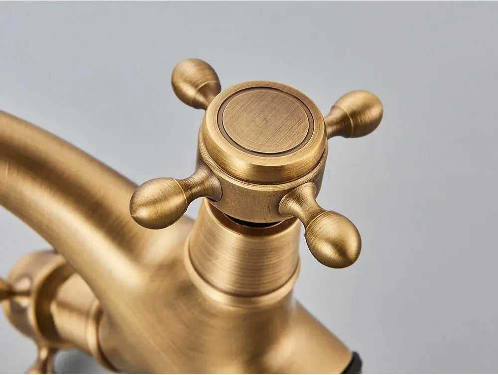 Antique brass two-handle deck-mounted bathroom faucet with cross-style knobs by Simples Market