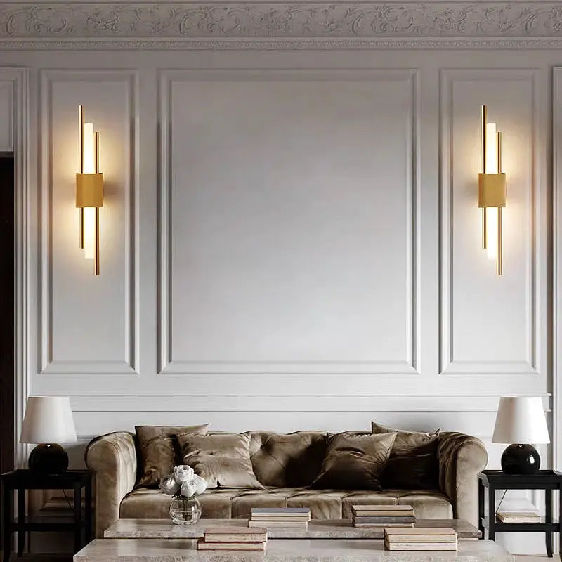 Nordic LED wall lamps set of 2 in gold metal on white paneled wall with warm lighting.